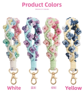 Detail of four colorful handmade bohemian woven flower keychains with gold lobster clasps