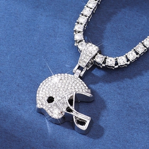 Macro shot of hip hop football helmet pendant with sparkling crystals on tennis chain