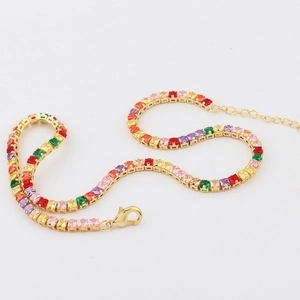 Detailed close-up of a gold chain necklace with colorful square-cut zircon stones