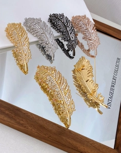 Exquisite zircon feather brooches in gold silver and rose gold with mirror reflection