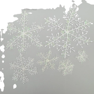 White Christmas snowflake ornaments in various sizes with iridescent glitter finish