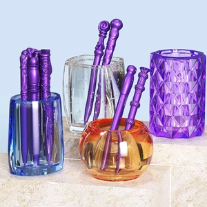 Detailed view of magic wand style ballpoint pens with purple finish and glass containers