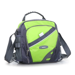 Detail of outdoor hiking crossbody bag featuring water-resistant green nylon fabric