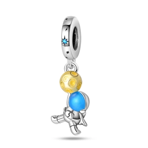 Detail of silver-plated astronaut and yellow moon pendant with blue enamel finish