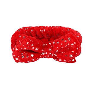 Close-up of red plush headband featuring silver star patterns and a large bow detail