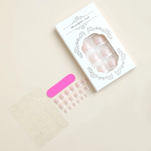 Flat lay of nude French press-on toe nails with jelly glue and pink mini nail file