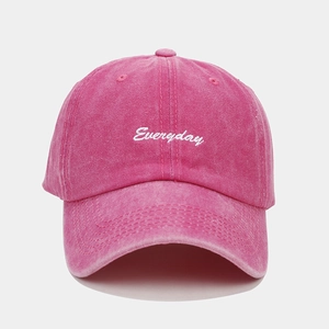 Detail of rose pink washed cotton baseball cap with white Everyday script embroidery