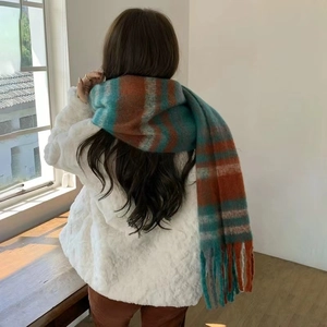Close-up of thick rainbow check scarf with fringe detail and soft brushed texture