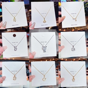 Detail view of titanium steel necklaces with heart, rabbit, and star pendants in gold and silver