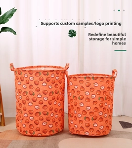 Detail of strawberry print fabric storage baskets with durable handles for laundry