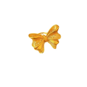 Vintage golden butterfly ring with matte finish and filigree hollow texture on white background