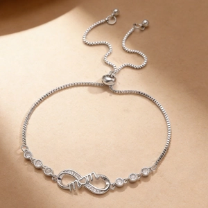 Close-up of infinity symbol bracelet with mom text and adjustable sliding buckle