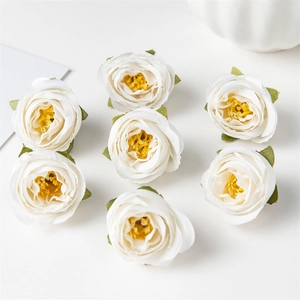 Close-up of seven realistic silk rose flower heads in white and yellow for DIY crafts