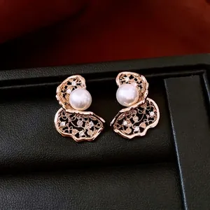 18K gold plated silver stud earrings with shell pearl and hollow flower petal design
