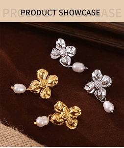 Detail view of gold and silver flower earrings with elegant teardrop pearls on dark brown velvet