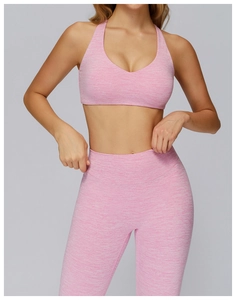 Close-up of pink heathered fabric texture on racerback yoga bra and leggings set