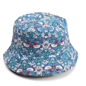Detail of floral bucket hat featuring vintage bird and strawberry botanical prints