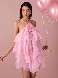 Pink tiered ruffle halter mini dress with a large 3D floral accent for summer vacation
