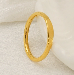 Detail of minimalist 18K gold plated titanium steel ring on textured white fabric
