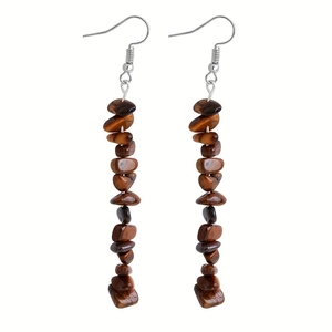 Macro shot of long drop earrings with irregular tiger eye stone beads on silver hooks
