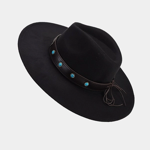 Detail of black wide brim fedora hat with brown leather band and turquoise studs