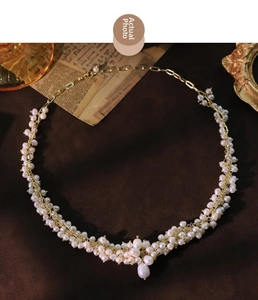 Detail of woven freshwater pearl necklace with gold wire and a large teardrop pendant
