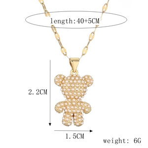 Detail of gold teddy bear pendant with pearls and dimensions 2.2x1.5cm on O-chain necklace
