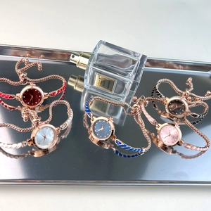 Slim rose gold quartz watch bracelets with colorful enamel detailing on metal tray