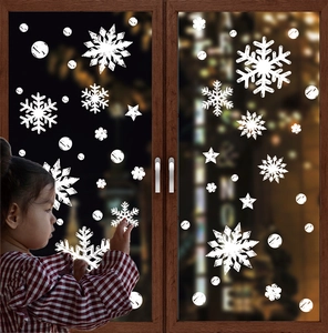 Close-up of white Christmas snowflake and star window stickers with a bokeh background