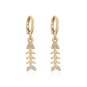 Macro shot of gold-plated fishbone earrings with sparkling zircon micro-inlays