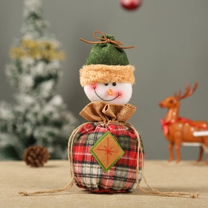 Detail of Christmas snowman drawstring gift bag with festive red and green plaid fabric