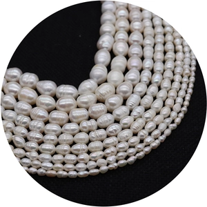 Natural white freshwater pearls for DIY jewelry making on a black textured background