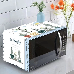 Detail of white lace dust cover with cactus patterns and wavy edges for microwaves