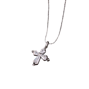 Minimalist silver cross pendant necklace with clear zircon inlay on a white background