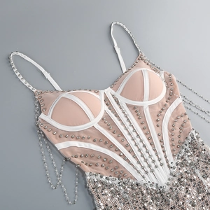 Detail of sequins and silver rhinestone chains on a sheer mesh sequin party dress