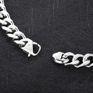 Macro shot of 14mm silver stainless steel Cuban link chain with a secure lobster clasp