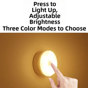 Detail of round touch bedside lamp showing three color modes and dimmable brightness level