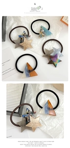 Detail of star and triangle hair ties with tortoiseshell patterns and glitter resin