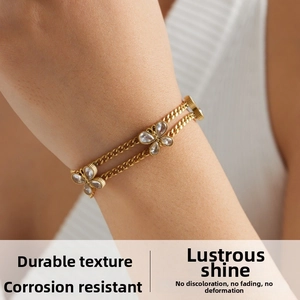 Close-up of double-layer gold butterfly bracelet with sparkling crystal on a wrist