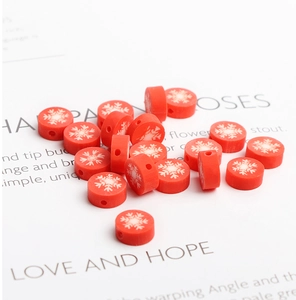 Detailed macro view of red polymer clay snowflake beads for DIY jewelry making and crafts