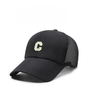 Close-up of black sports cap with breathable mesh and white 'C' towel embroidery