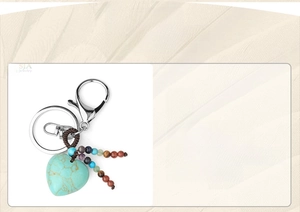 Macro shot of heart-shaped turquoise stone with multicolor beads on metal keychain
