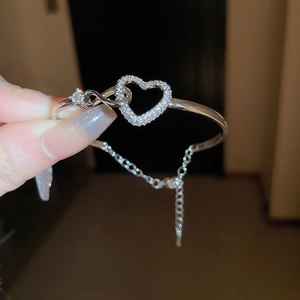 Detail of silver heart bracelet with pavé cubic zirconia and adjustable chain link