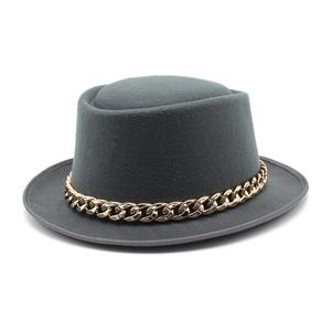 Detailed view of dark grey wool felt pork pie hat featuring a chunky gold metal chain