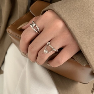 Detailed close-up of S925 silver smiley face and Happy engraving ring on finger