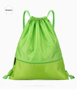 Close-up of green drawstring backpack featuring honeycomb texture and front zipper pocket