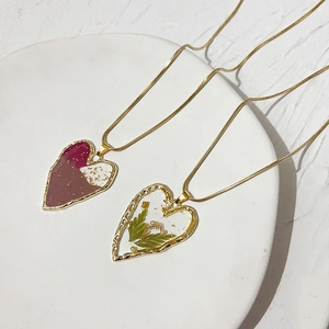 Golden square snake chain necklace with pink resin heart pendant and gold leaf foil