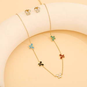 Parure élégante collier et boucles d'oreilles papillon en acier doré avec incrustations