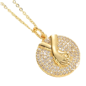 Gold plated hand holding hand pendant necklace with sparkling cubic zirconia pavé setting