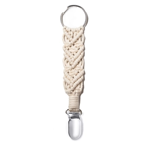Macro shot of hand-woven cream cotton hat clip with metal ring and sturdy travel buckle